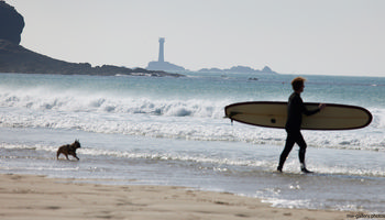 Surfer and dog Longships beach.jpg